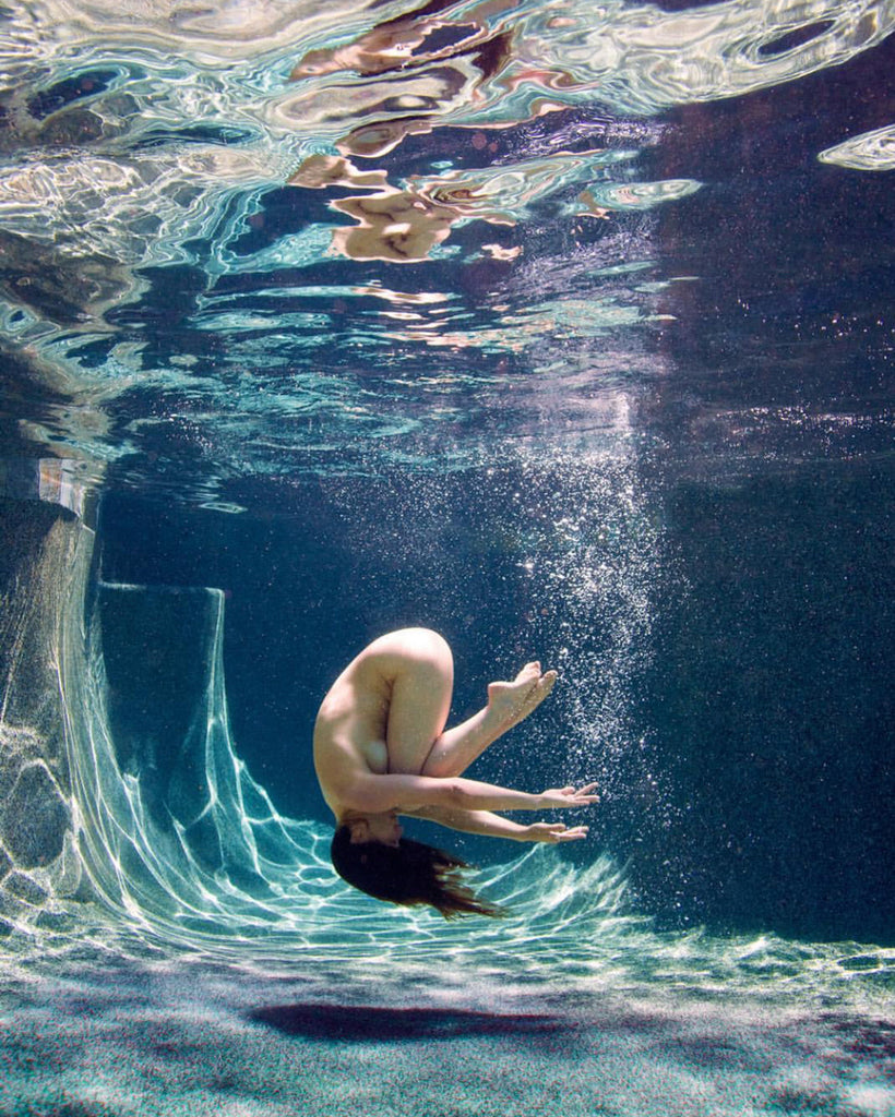 nude women swimming underwater